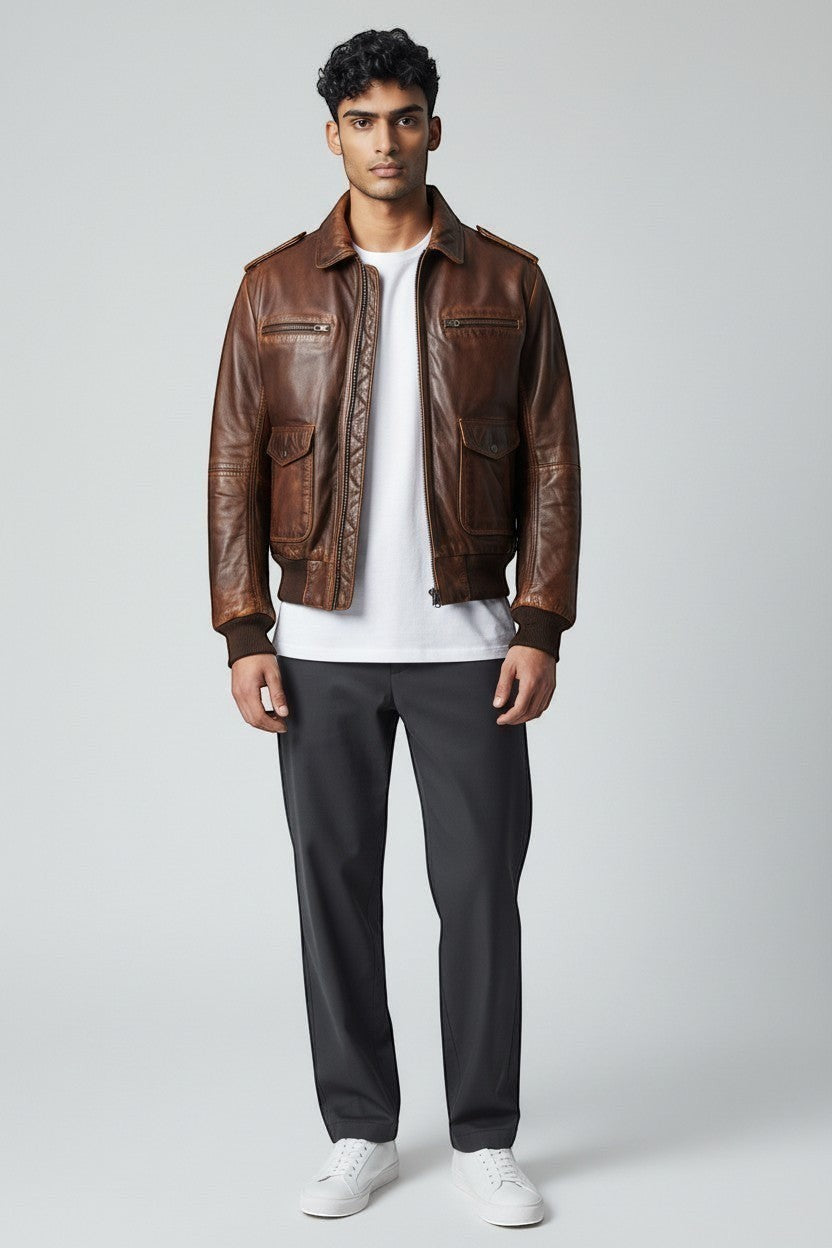 Scarlett Stitch Men's distressed brown leather bomber jacket with shirt collar, zippered front, and ribbed cuffs.