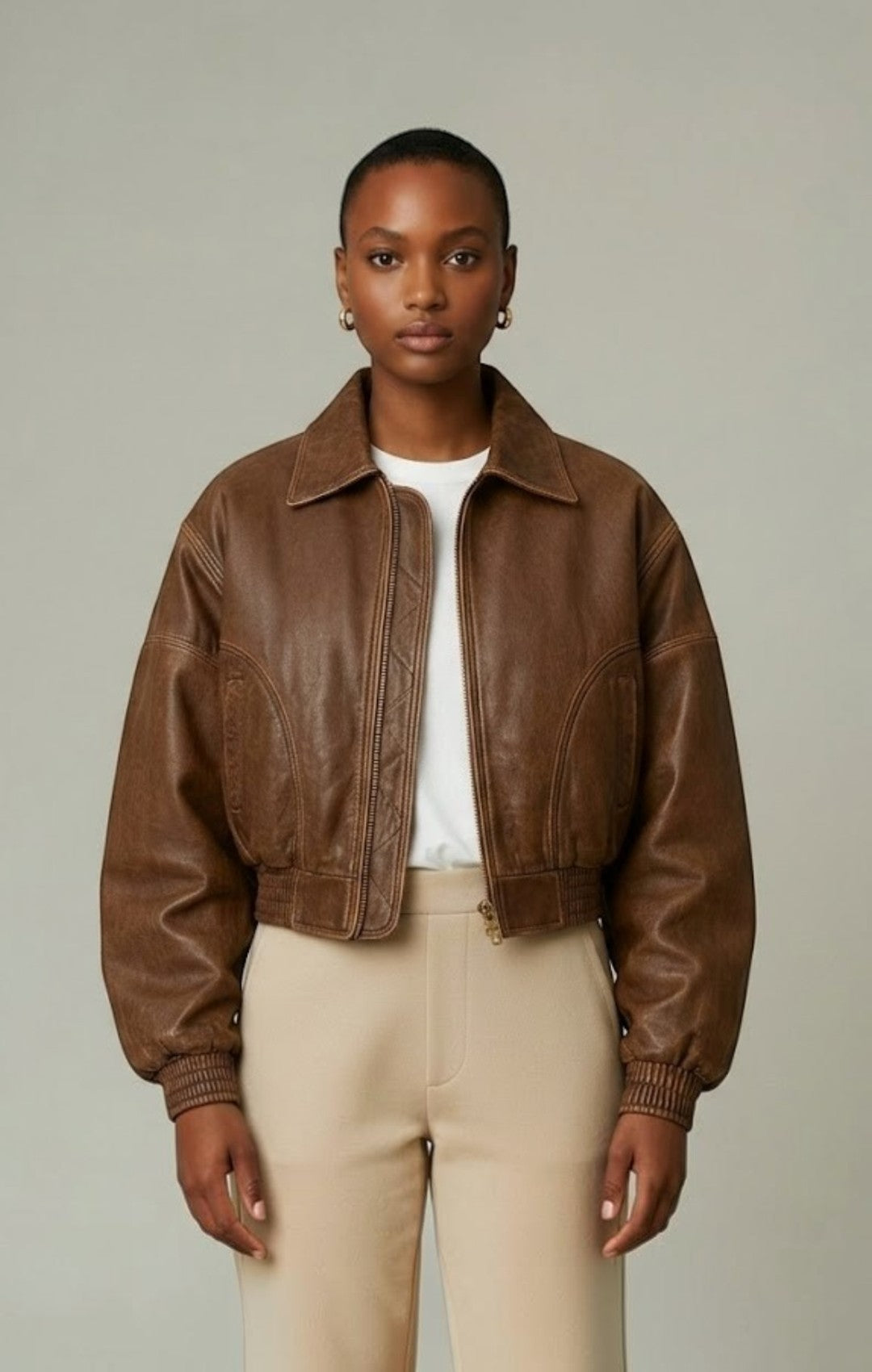 Scarlett Stitch distressed brown leather cropped bomber jacket with collar and zip-front closure.