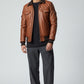 Scarlett Stitch Men's brown quilted faux leather bomber jacket with ribbed collar, cuffs, and hem. Features dual chest and side pockets.