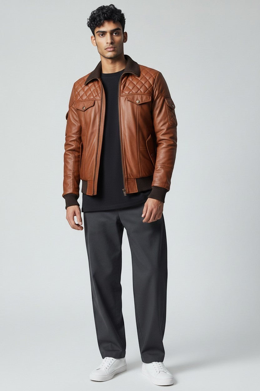 Scarlett Stitch Men's brown quilted faux leather bomber jacket with ribbed collar, cuffs, and hem. Features dual chest and side pockets.