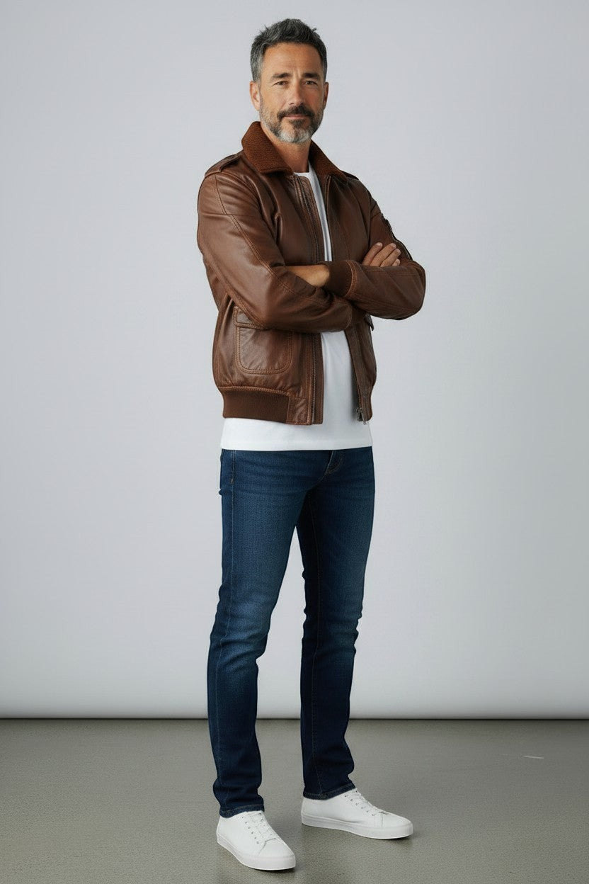 Scarlett Stitch Men's classic brown leather bomber jacket with ribbed collar, cuffs, and hem. Features epaulets and zip front.