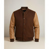 Scarlett Stitch Men's brown wool-blend varsity bomber jacket with tan leather sleeves, ribbed collar, cuffs, and hem.
