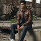 Scarlett Stitch distressed brown leather bomber jacket with shirt collar, zipper, and ribbed cuffs on a man.