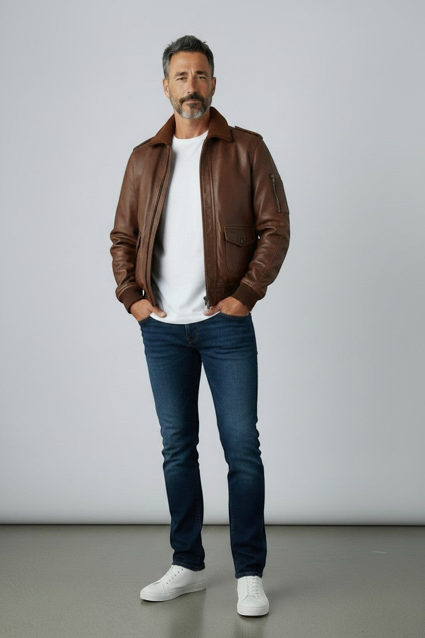 Scarlett Stitch Men's classic brown leather bomber jacket with ribbed collar, cuffs, and hem. Features epaulets and zip front.