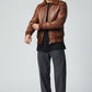 Scarlett Stitch Men's brown genuine leather bomber jacket with ribbed collar, cuffs, and hem. Features zipper, flap pockets, and epaulets.