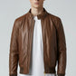 Scarlett Stitch men's brown quilted faux leather bomber jacket with stand collar and ribbed cuffs.