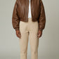 Scarlett Stitch distressed brown leather cropped bomber jacket with collar, zip-front, and elasticated cuffs.