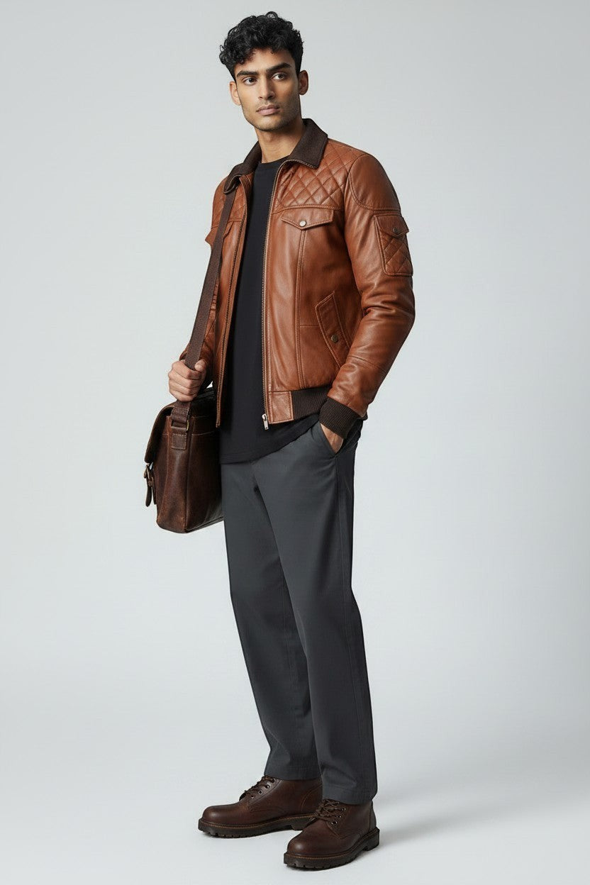 Scarlett Stitch men's brown quilted faux leather bomber jacket with ribbed collar, cuffs, and hem. Features chest and side pockets.