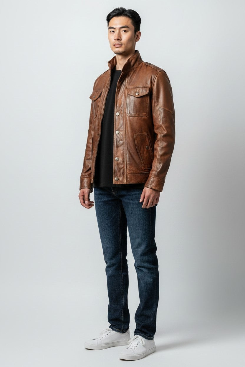 Scarlett Stitch brown leather field jacket with chest pockets and stand-up collar worn by a man with dark denim jeans