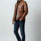Scarlett Stitch men's brown leather field jacket with chest pockets and stand-up collar worn by a male model