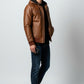 Scarlett Stitch men's distressed brown leather bomber jacket with attached hood, ribbed cuffs, and zip-up front.