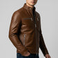 Man wearing a Scarlett Stitch brown leather jacket with a stand-up collar, metal zippers, and tailored fit.