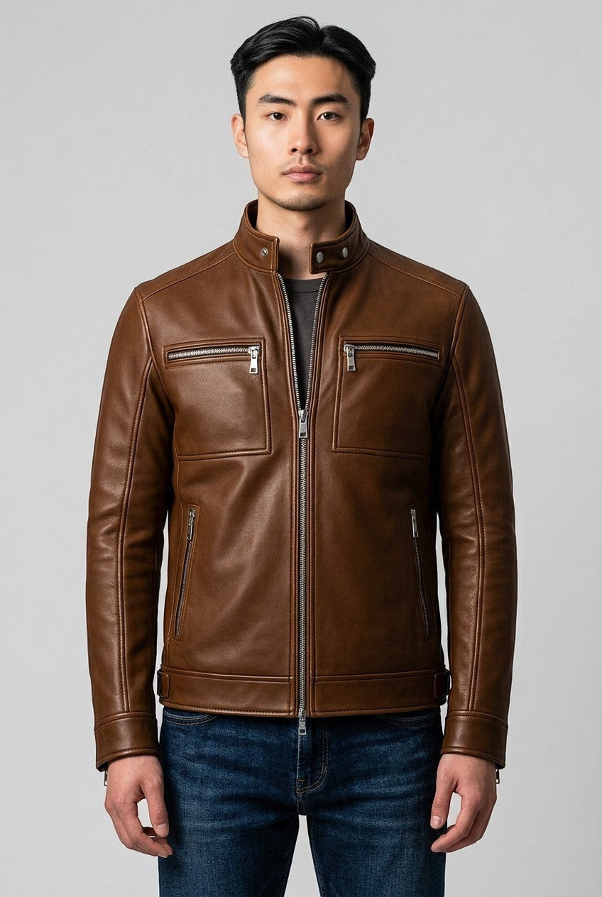 Scarlett Stitch men's brown leather jacket with stand-up collar, metal zippers, and chest pockets on a male model.