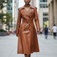 Scarlett Stitch brown leather trench coat with belt, double-breasted, epaulets, and flared skirt.