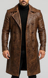 Scarlett Stitch men's brown distressed leather double-breasted trench coat with lapel collar worn over a black turtleneck.
