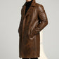 Scarlett Stitch men's brown distressed leather double-breasted trench coat worn over a black turtleneck