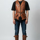 Model wearing a Scarlett Stitch brown distressed leather utility vest with front pockets, zipper, and waist belt.