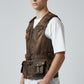 Model wearing a brown distressed leather utility vest by Scarlett Stitch with multiple pockets and adjustable belt.