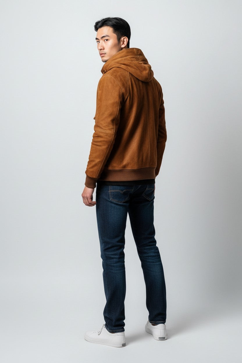 Scarlett Stitch brown suede bomber jacket with hood on a man wearing jeans and white sneakers.