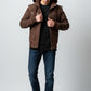 Scarlett Stitch Men's brown suede hooded bomber jacket with zip front, ribbed cuffs, and epaulet details.
