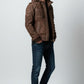 Scarlett Stitch Men's brown suede hooded bomber jacket with zip pockets and epaulet details.