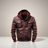 Scarlett Stitch burgundy faux leather hooded bomber jacket with ribbed cuffs and hem, and two chest pockets.