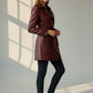 Scarlett Stitch burgundy faux leather double-breasted belted trench coat worn by a model with black jeans and sneakers