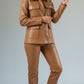 Scarlett Stitch caramel faux leather utility jacket with four front pockets and gold buttons, worn by a model.