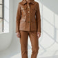Scarlett Stitch caramel faux leather utility jacket with four front pockets and gold buttons. Model wears matching pants.