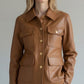 Scarlett Stitch caramel faux leather utility jacket with four front pockets and gold-tone buttons.