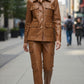 Scarlett Stitch caramel faux leather utility jacket with four front pockets and gold-tone buttons.