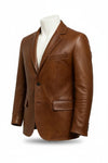 Scarlett Stitch cognac brown leather blazer with notch lapels, single-button closure, and flap pockets on a mannequin.