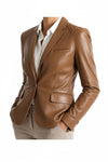 Scarlett Stitch cognac brown leather blazer with notched lapels, flap pockets, and a tailored two-button closure.