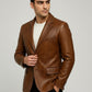 Man wearing a Scarlett Stitch cognac brown leather blazer with notch lapels and a single-button closure.