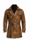 Scarlett Stitch cognac brown distressed leather double-breasted trench coat with belt, epaulettes, and notch lapels.