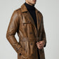 Scarlett Stitch men's cognac brown distressed leather trench coat with double-breasted front, belt, and epaulettes.