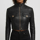 Scarlett Stitch black faux leather cropped moto jacket with diamond quilting on shoulders and ribbed sleeves.