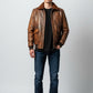 Scarlett Stitch Men's distressed brown faux leather bomber jacket with shearling collar, ribbed cuffs and hem, and flap pockets.