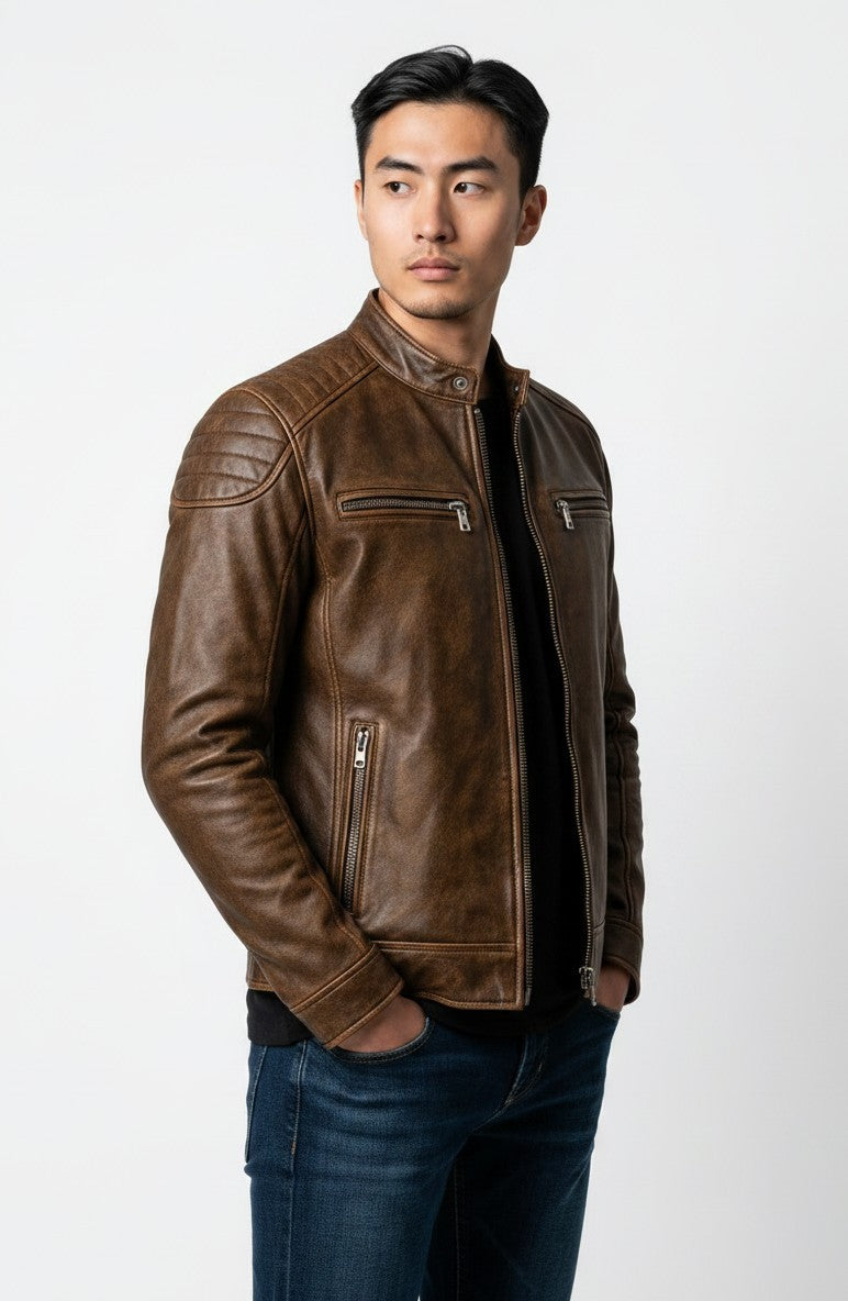 Scarlett Stitch men's distressed brown leather cafe racer jacket with quilted shoulders and zippered pockets.