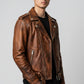 Scarlett Stitch distressed brown leather motorcycle jacket with asymmetrical zip and belt on a male model