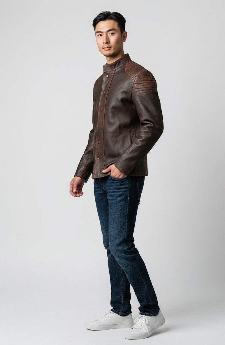 Scarlett Stitch men's distressed brown leather jacket with quilted shoulders and mandarin collar worn with jeans.