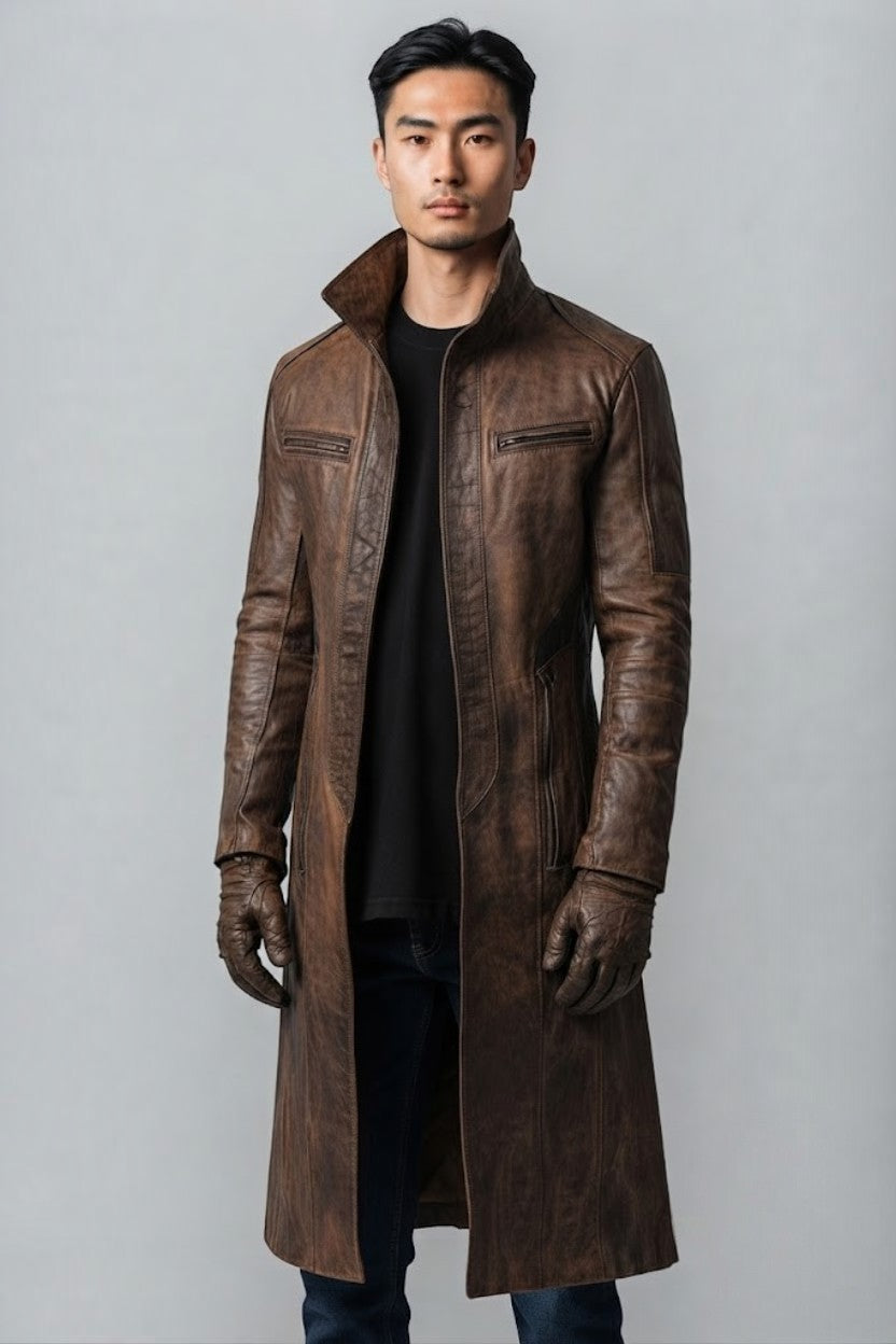Scarlett Stitch men's distressed brown leather trench coat with a high-neck collar and zippered pockets on a model.