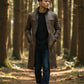 Scarlett Stitch men's distressed brown leather trench coat with high collar worn by a man in a forest setting.