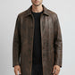 Scarlett Stitch men's distressed brown leather trench coat with a structured collar and button-front closure.
