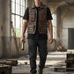 Man wearing a Scarlett Stitch distressed brown leather utility vest with multiple pockets in an industrial warehouse.