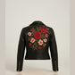 Scarlett Stitch black faux leather moto jacket with embroidered red and pink roses on the back. Features zippered cuffs.