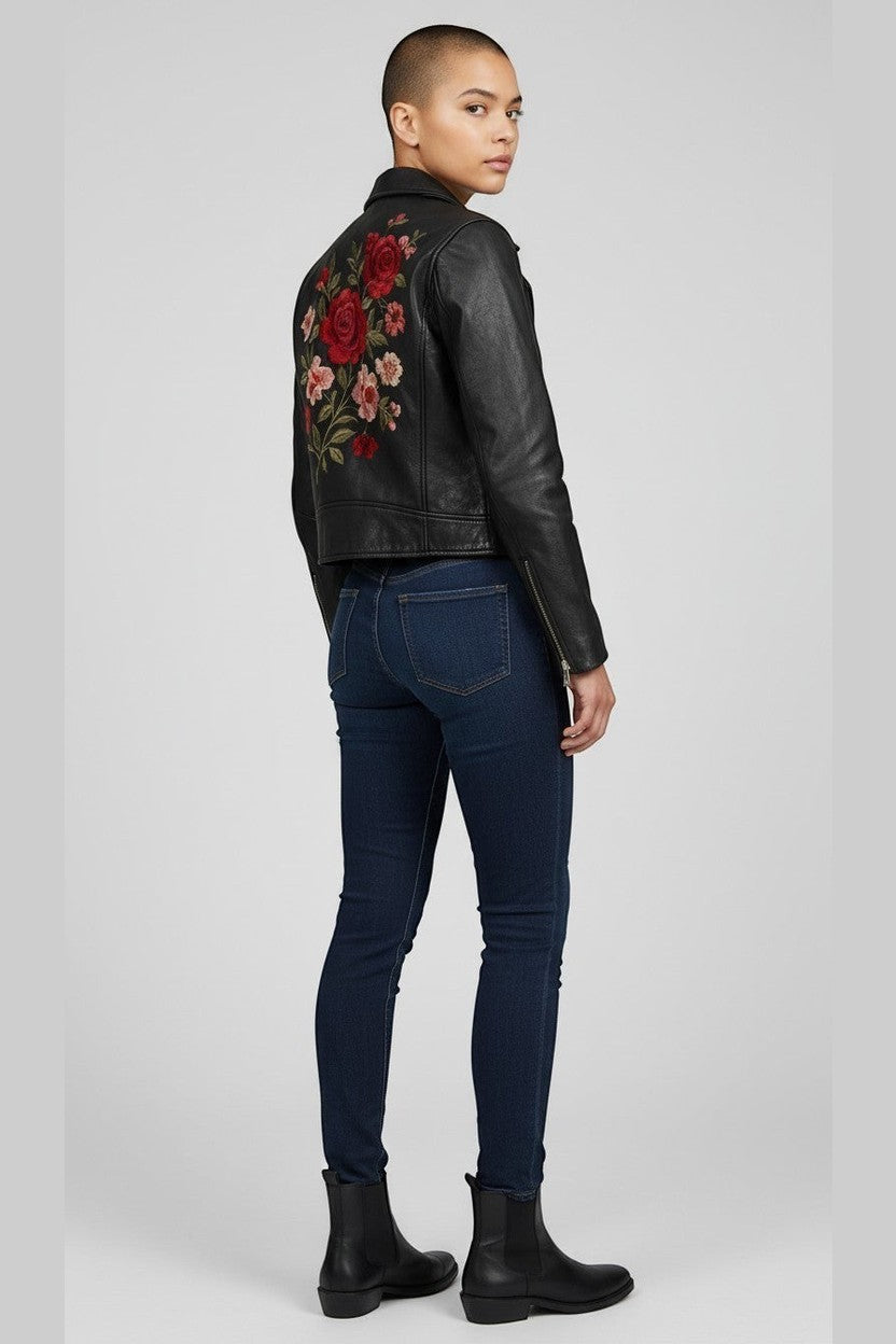 Scarlett Stitch black faux leather moto jacket with embroidered red and pink roses on the back. Classic biker style with zippered cuffs.