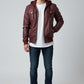 Scarlett Stitch burgundy faux leather hooded bomber jacket with zip front, chest pockets, and ribbed cuffs and hem.
