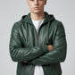 Scarlett Stitch forest green faux leather hooded bomber jacket with zip-front, ribbed cuffs, and adjustable drawstrings.