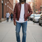 Scarlett Stitch men's burgundy leather hooded bomber jacket with quilted shoulders and zippered pockets.